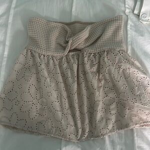 Cream mini bubble crop top with tie front and smocked design for casual wear